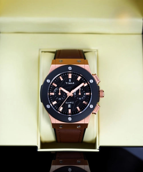 Watch with brown strap and black dial in a box, brand 'TIMAS' visible